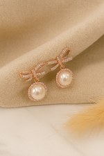 A Classic Twisted Bow With Rose Gold Touch Earrings